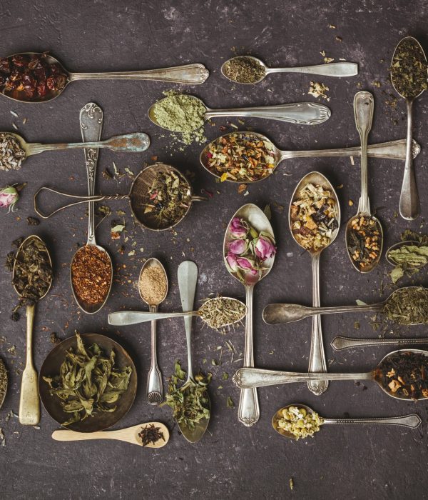 Assortment of dry tea in vintage spoons